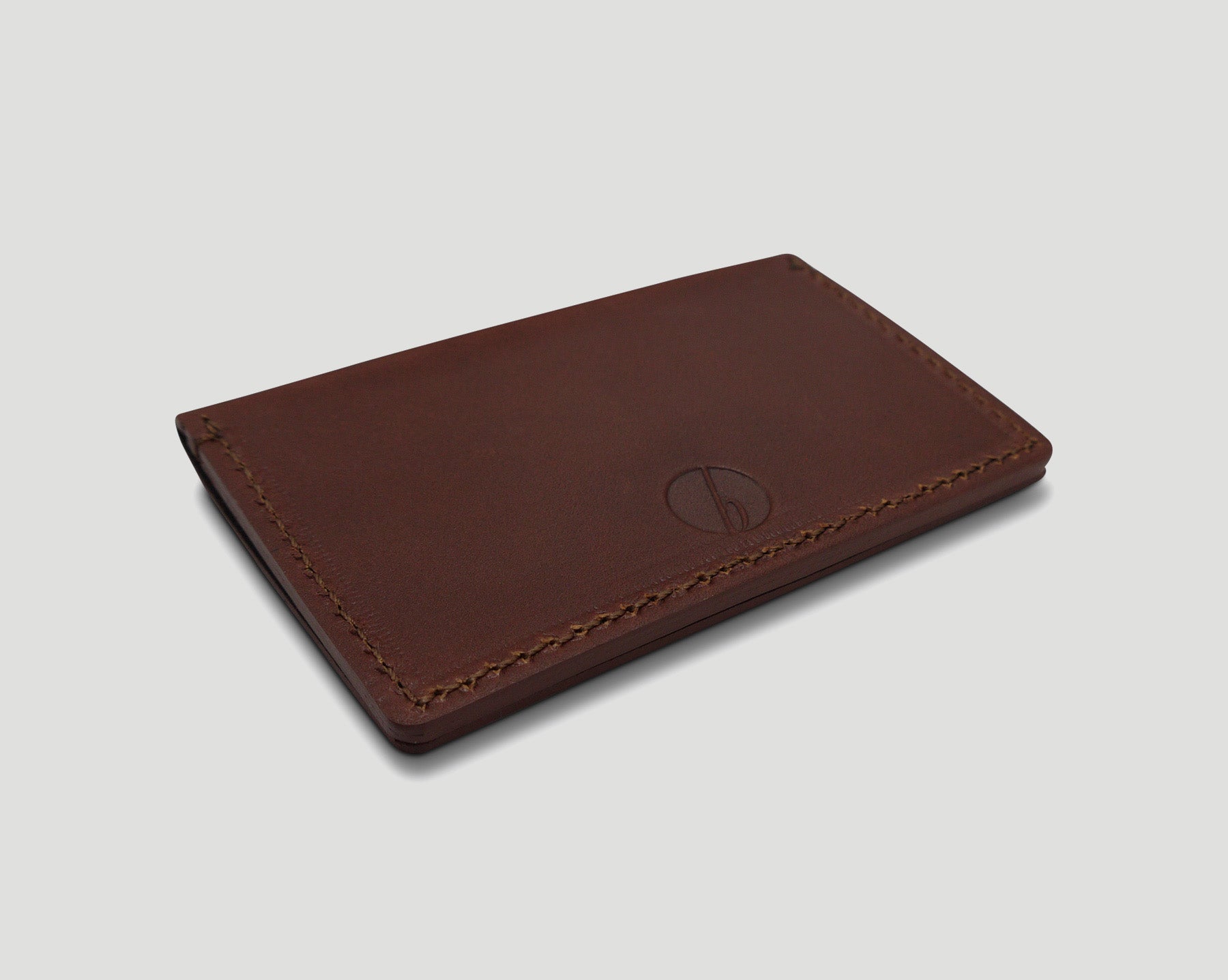 Back of brown full grain leather bifold card holder. 