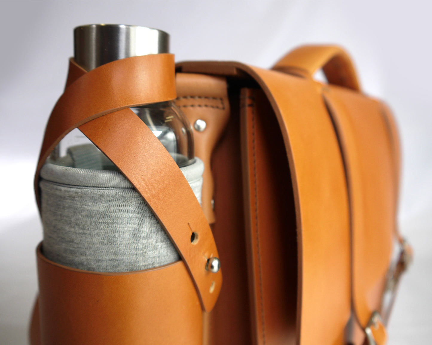 Close up of the full grain medium brown bottle holder strap