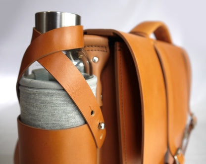Close up of the full grain medium brown bottle holder strap