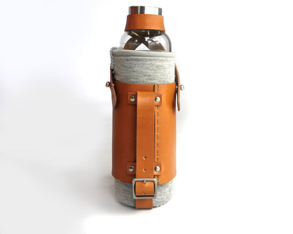 Basader bottle holder shown with a water bottle in english tan full grain leather